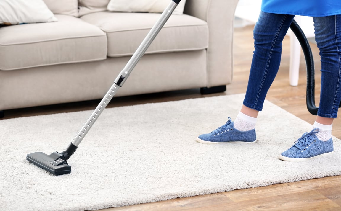 Person Cleaning Carpet with Vaccum